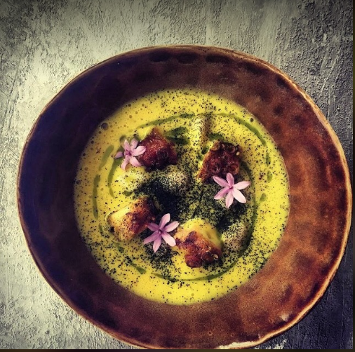 Plate of tender gnocchi served with crispy tempura octopus, garnished with herbs and a drizzle of sauce, creating a fusion of textures and flavors prepared by private chef in Barcelona